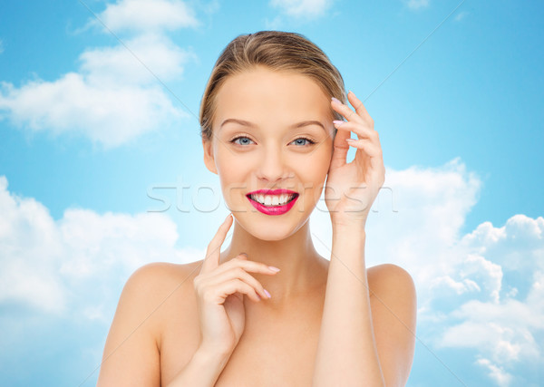 smiling young woman with pink lipstick on lips Stock photo © dolgachov