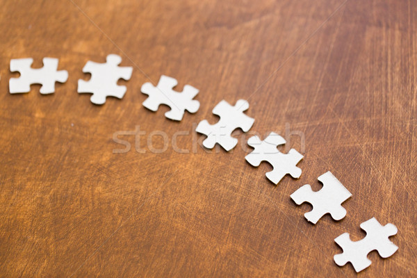 Stock photo: close up of puzzle pieces on wooden surface