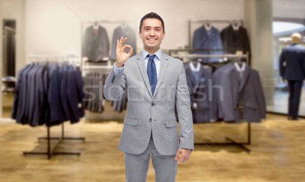 happy businessman in suit over clothing store Stock photo © dolgachov