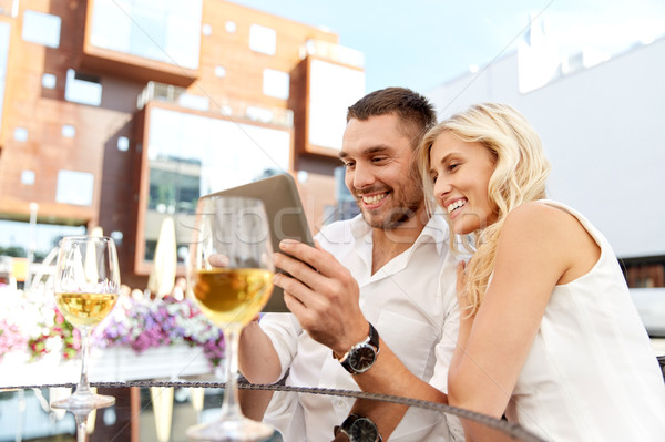 happy couple with tablet pc at restaurant terrace Stock photo © dolgachov
