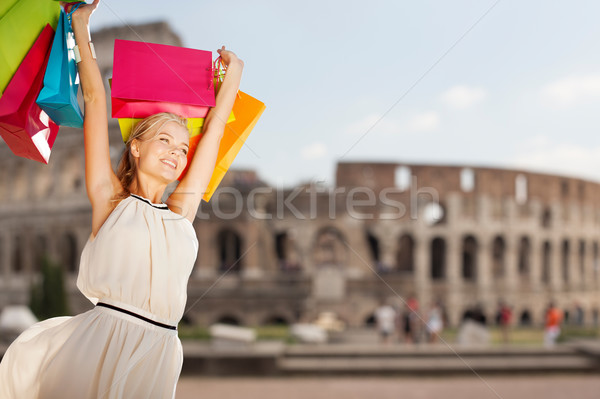 happy woman with shopping bags over coliseum Stock photo © dolgachov