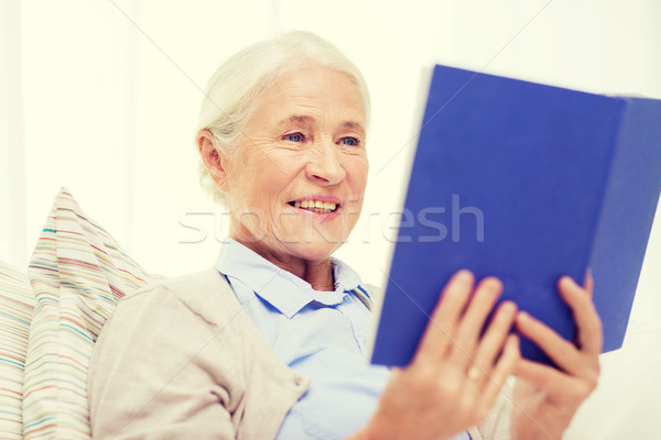 happy smiling senior woman reading book at home Stock photo © dolgachov
