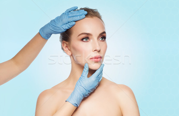 Stock photo: surgeon or beautician hands touching woman face