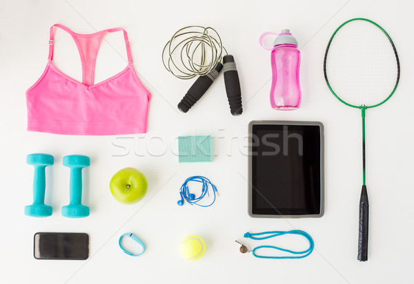 close up of tablet pc, cellphone and sports stuff Stock photo © dolgachov