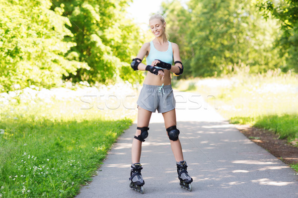 happy young woman in rollerblades riding outdoors Stock photo © dolgachov