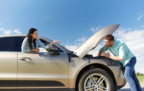 couple with open hood of broken car at countryside Stock photo © dolgachov