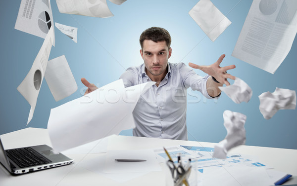 Mérges üzletember dob papírok iroda üzletemberek Stock fotó © dolgachov