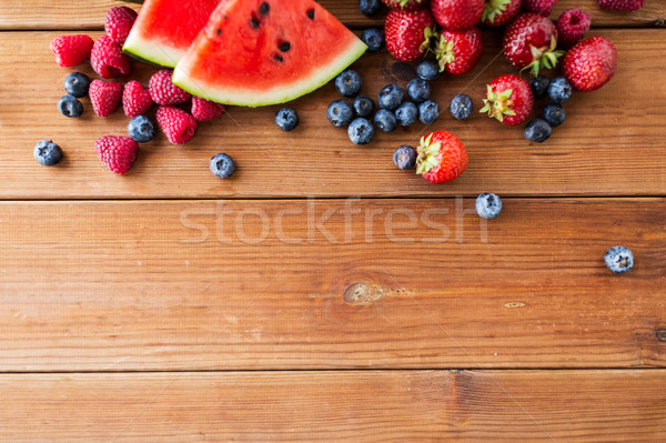 close up of fruits and berries on wooden table Stock photo © dolgachov