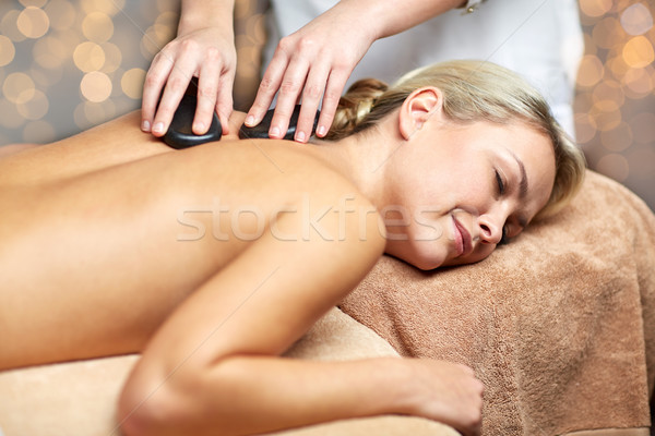 close up of woman having hot stone massage in spa Stock photo © dolgachov