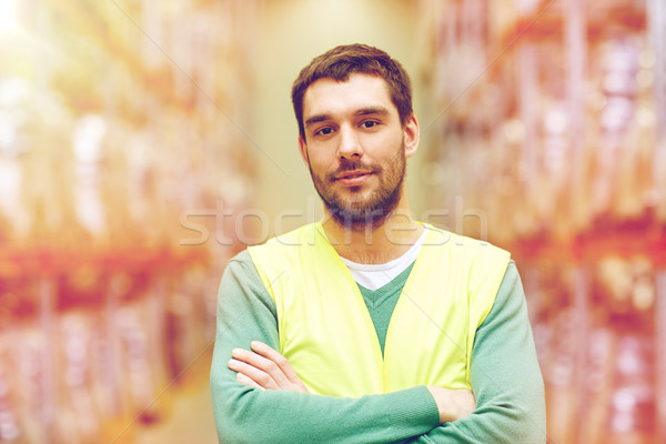 happy man in reflective safety vest at warehouse Stock photo © dolgachov