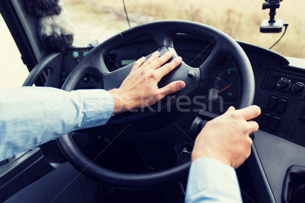 close up of driver driving passenger bus Stock photo © dolgachov