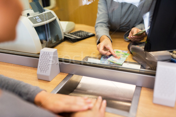 clerk counting cash money at bank office Stock photo © dolgachov