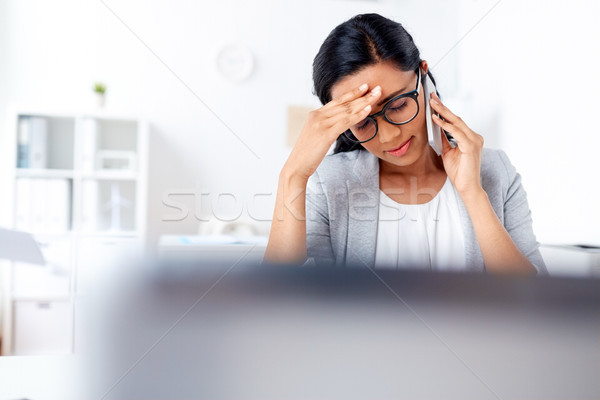 Stock photo: businesswoman calling on smartphone at office