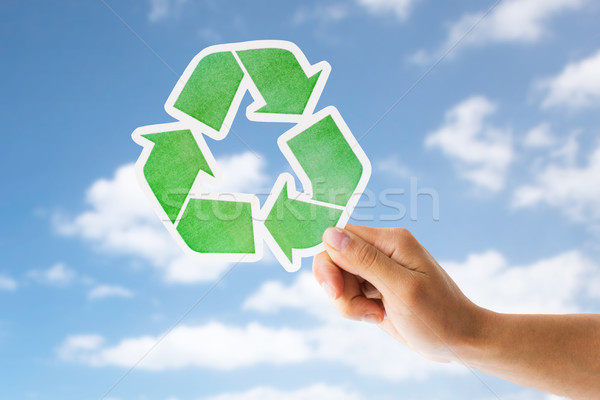 close up of hand with green recycle sign over sky Stock photo © dolgachov