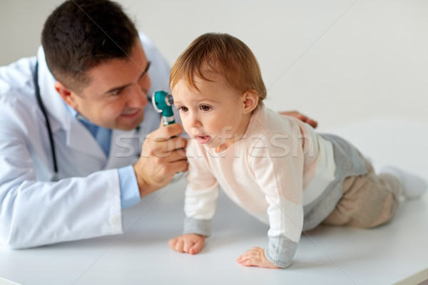 doctor with otoscope checking baby ear at clinic Stock photo © dolgachov
