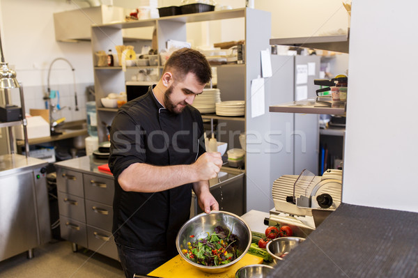 chef cook making food at restaurant kitchen Stock photo © dolgachov