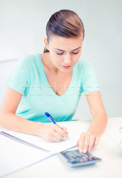 student girl with notebook and calculator Stock photo © dolgachov