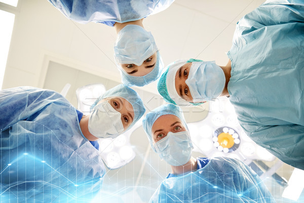 group of surgeons in operating room at hospital Stock photo © dolgachov