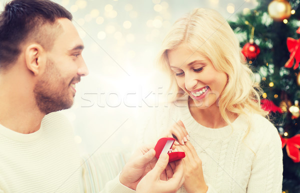 man giving woman engagement ring for christmas Stock photo © dolgachov