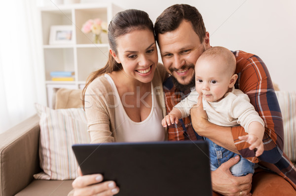 Stock photo: mother, father and baby with tablet pc at home