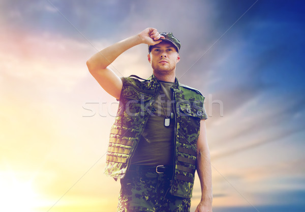 soldier in military uniform over sky background Stock photo © dolgachov