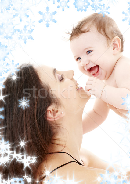 laughing blue-eyed baby playing with mom Stock photo © dolgachov