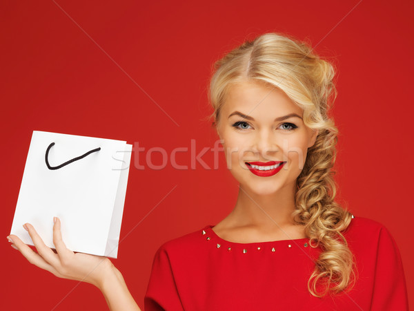 lovely woman in red dress with shopping bag Stock photo © dolgachov