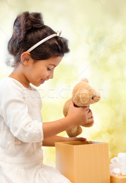 happy child girl with gift box and teddy bear Stock photo © dolgachov