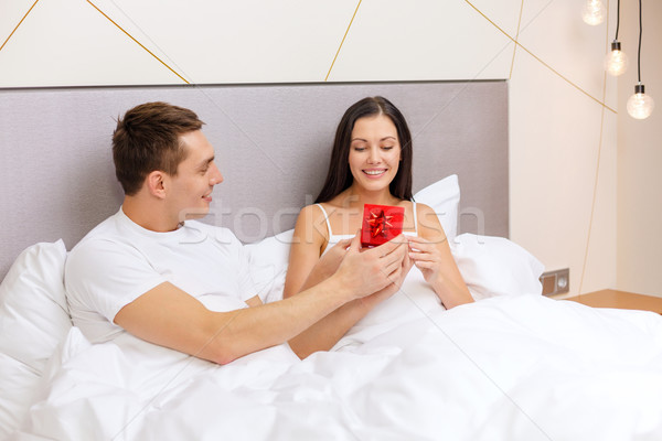 man giving woman little red gift box Stock photo © dolgachov