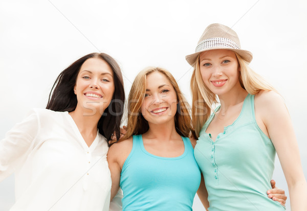 Stock photo: group of smiling girls chilling on the beach