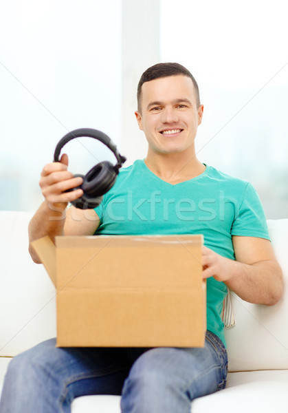 opening cardboard box and taking out headphones Stock photo © dolgachov