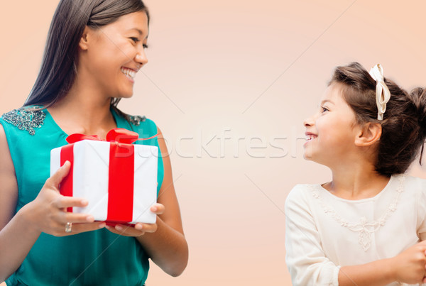 happy mother and child girl with gift box Stock photo © dolgachov