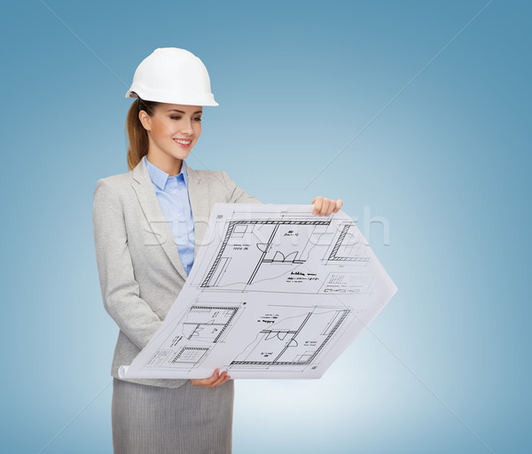 Stock photo: smiling architect in white helmet with blueprints