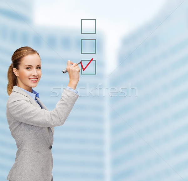 businesswoman writing something in air with marker Stock photo © dolgachov