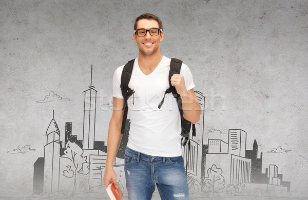 smiling student with backpack and book Stock photo © dolgachov