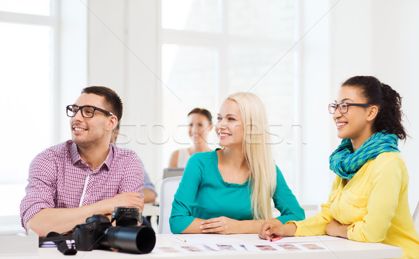 smiling team with photocamera working in office Stock photo © dolgachov