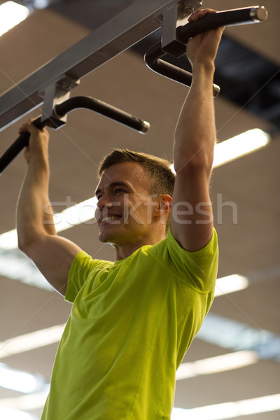 smiling man exercising in gym Stock photo © dolgachov