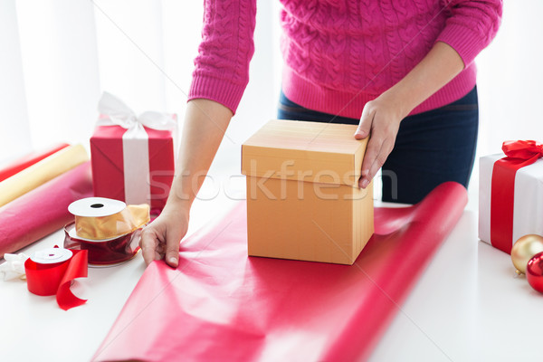 close up of woman decorating christmas presents Stock photo © dolgachov