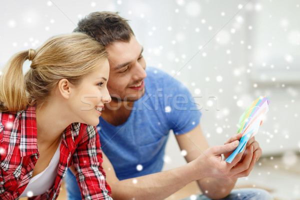 smiling couple selecting color from samples Stock photo © dolgachov