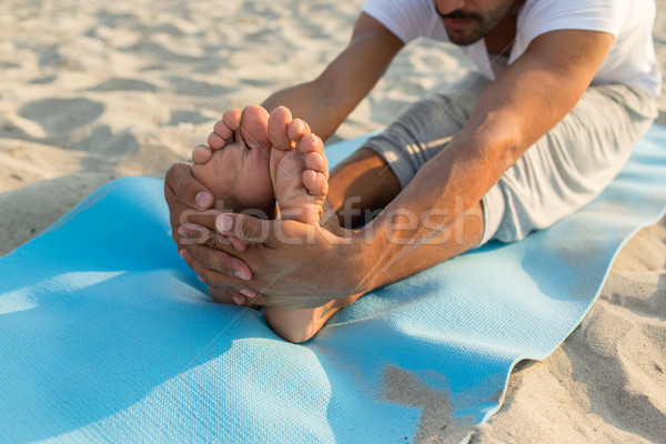 close up of man making yoga exercises outdoors Stock photo © dolgachov