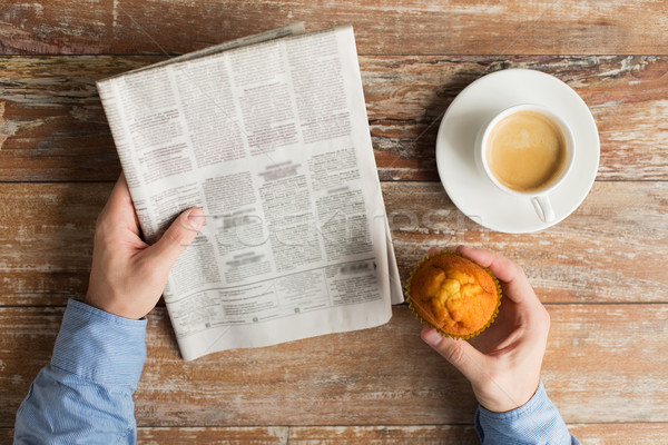 close up of male hands with newspaper and coffee Stock photo © dolgachov