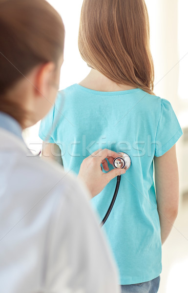 close up of girl and doctor on medical exam Stock photo © dolgachov