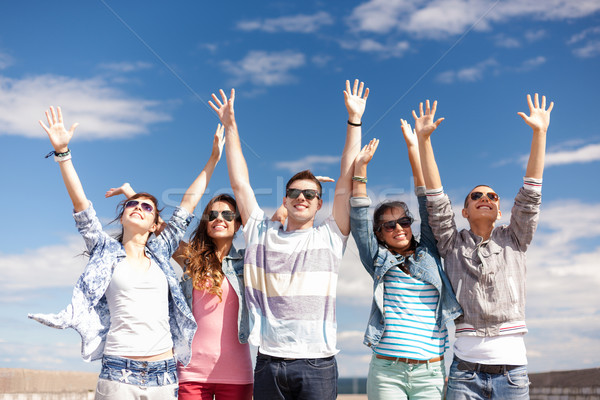 group of smiling teenagers holding hands up Stock photo © dolgachov