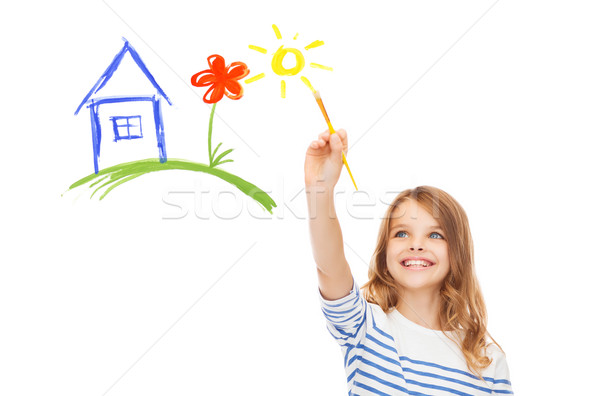 cute little girl drawing house with brush Stock photo © dolgachov