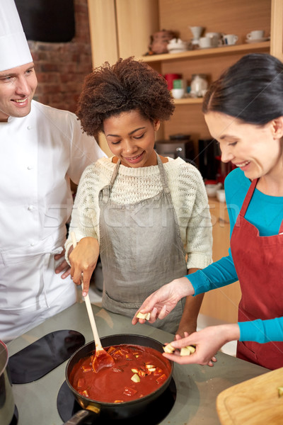 Stock photo: happy women and chef cook cooking in kitchen