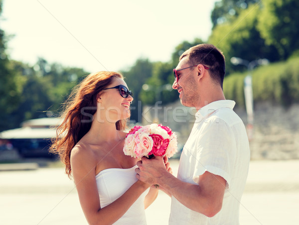 smiling couple in city Stock photo © dolgachov