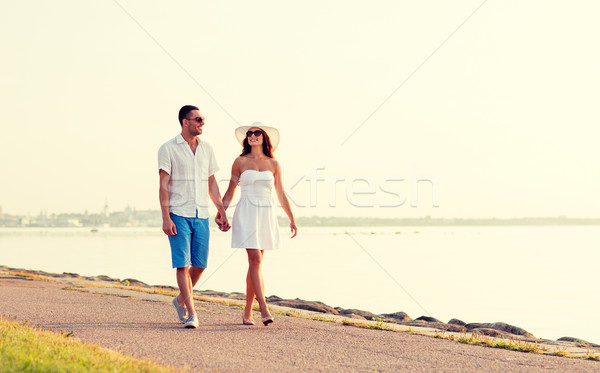 smiling couple walking outdoors Stock photo © dolgachov