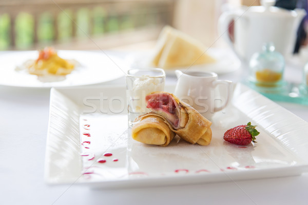 close up of pancakes and honey or jam on plate Stock photo © dolgachov