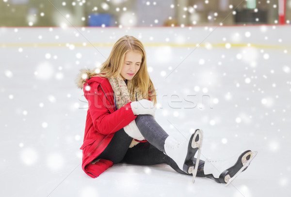 young woman fell down on skating rink Stock photo © dolgachov