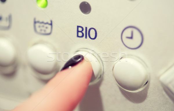 close up of woman finger pressing washer button Stock photo © dolgachov